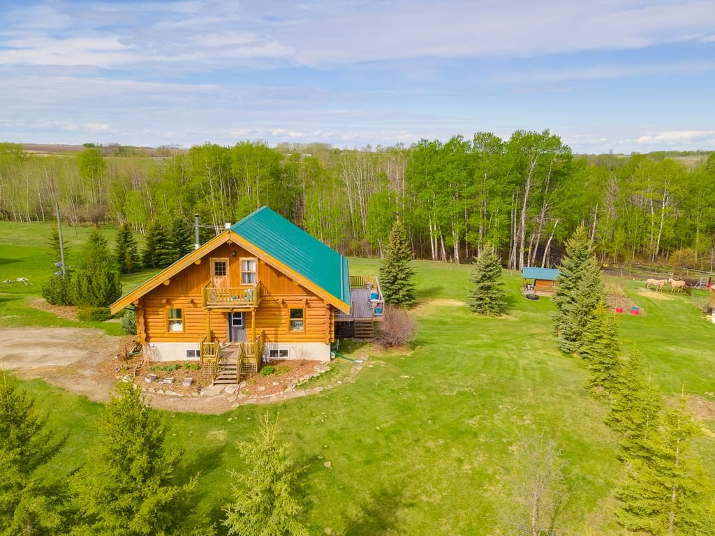 Aerial view of log house on an acreage near Olds Alberta